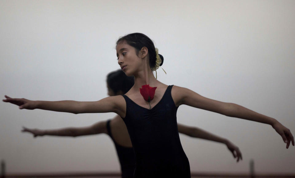 In this Aug. 28, 2012 photo, a dancer trains for a ballet competition at the National Superior Ballet School in Lima, Peru. Nearly 100 girls and boys from Colombia, Venezuela, Chile, France and Peru are submitting themselves to a week-long competition hoping to win medals from Peru's national ballet school _ and perhaps a grant to study in Miami. (AP Photo/Martin Mejia)