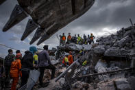 <p>An Indonesian search and rescue team looking for victims at a collapsed mosque following an earthquake in Tanjung on Aug. 7, 2018 in Lombok Island, Indonesia. (Photo: Ulet Ifansasti/Getty Images) </p>