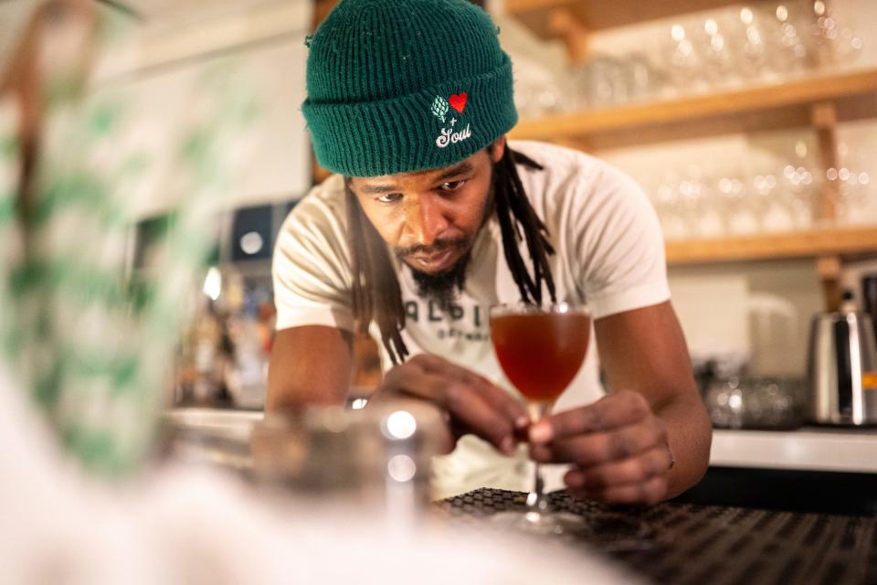 Beverage director Andre Sykes readies a mixed drink at Alpino in Detroit's Corktown neighborhood on Friday, February 16, 2024. The restaurant focuses on a cuisine inspired by the Alps and does so in a warm, elegant environment paired with excellent hospitality.
