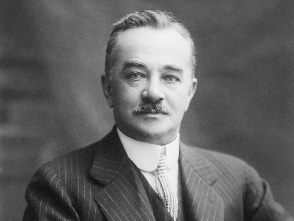 A black and white portrait of Milton S. Hershey wearing a striped suit with a ties.
