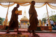 Buddhist monks arrive at a ceremony at a monument to remember the victims of a fatal 1997 grenade attack on an opposition rally in Phnom Penh, Cambodia, March 30, 2018. REUTERS/Samrang Pring