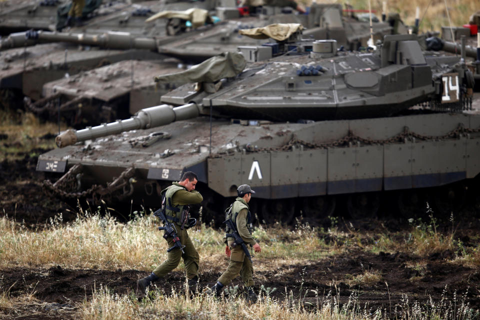 <p>Israeli soldiers walk next to tanks near the Israeli side of the border with Syria in the Israeli-occupied Golan Heights, Israel, May 9, 2018. (Photo: Amir Cohen/Reuters) </p>