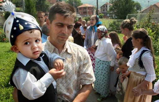 Kosovar Bosnian waits with his child for the circumcision in the village of Lubinje, in the Shar mountains that form the border between Kosovo and Macedonia. Every five years the people of the village organise a three-day Sunet (circumcision) Festival, where this year 90 boys, aged from 10 months to 5 years, were circumcised