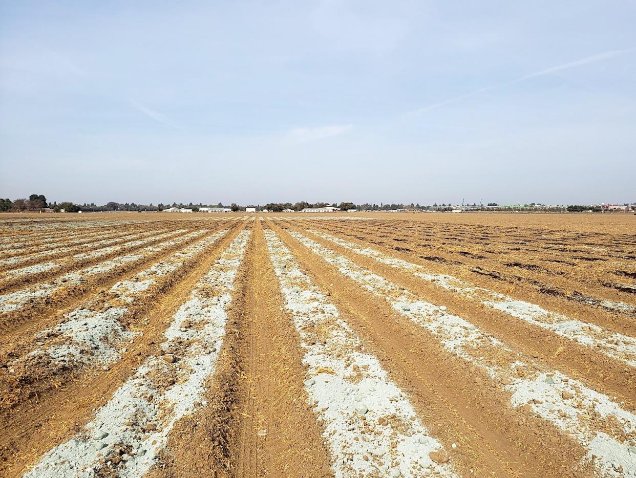 Rock dust applied to farmland in California. IRIS HOLZER