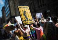 The crowd in Helsinki carried anti- Trump banners