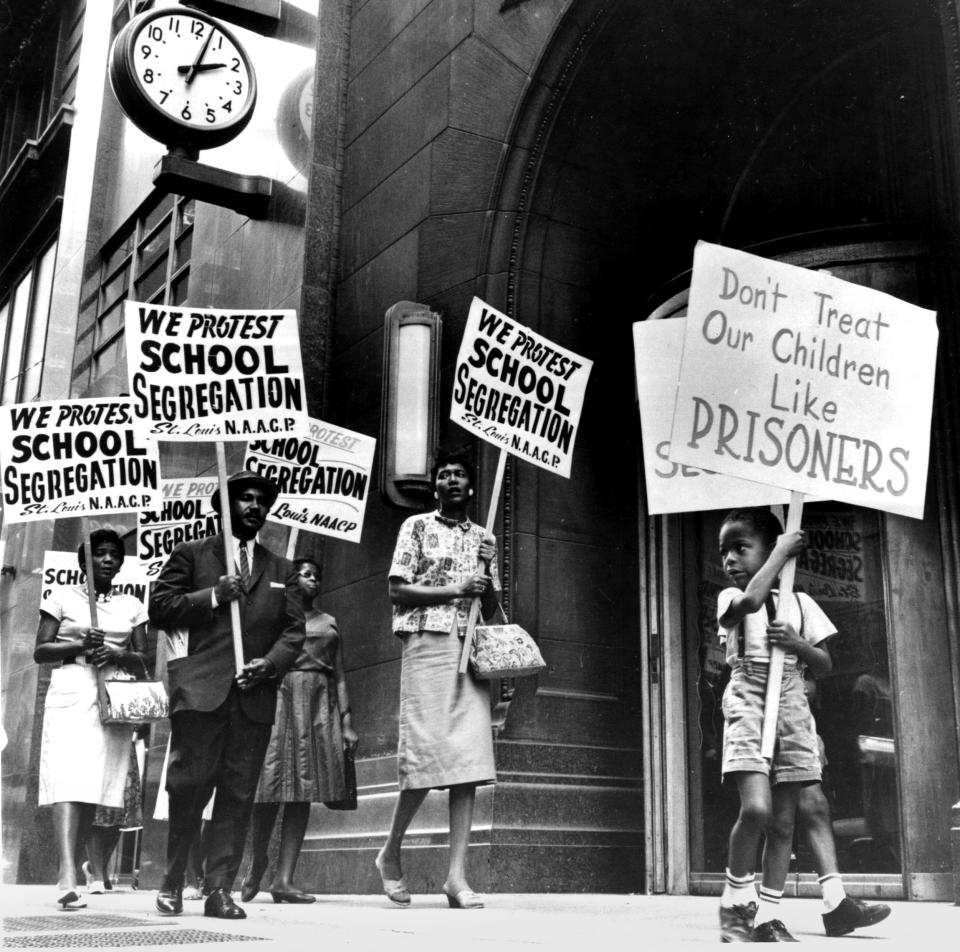 Demonstrators picket in front of a school board office in protest of segregation, in St. Louis, Mo., early 1960s. (PhotoQuest / Getty Images file)