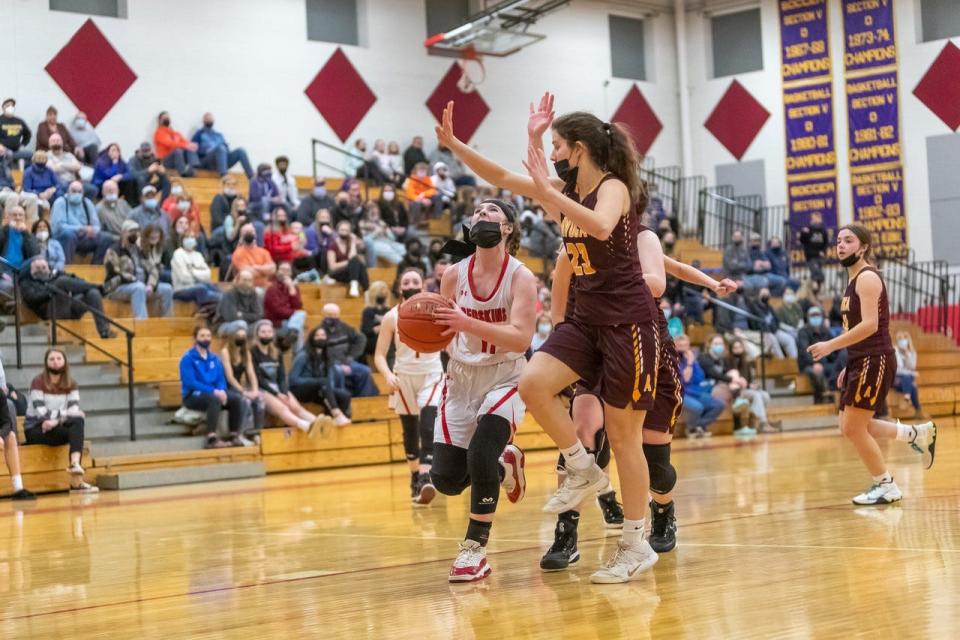 Canisteo-Greenwood's Lillian Mullen looks to get a layup as Avoca/Prattsburgh's Laura Morera plays defense.