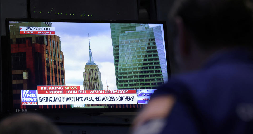 A screen at the New York Stock Exchange shows a news alert of an earthquake in New York City Friday. (Andrew Kelly/Reuters)

