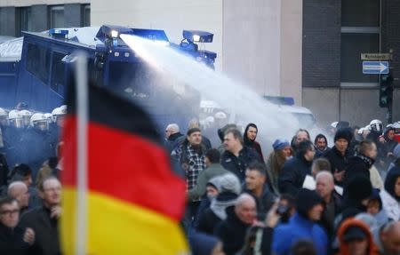 Police use a water cannon during a protest march by supporters of anti-immigration right-wing movement PEGIDA (Patriotic Europeans Against the Islamisation of the West) in Cologne, Germany, January 9, 2016. REUTERS/Wolfgang Rattay