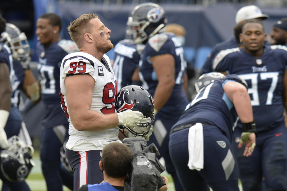 Houston Texans defensive end J.J. Watt (99) stands on the field as Tennessee Titans players celebrate after overtime of an NFL football game Sunday, Oct. 18, 2020, in Nashville, Tenn. The Titans won 42-36. (AP Photo/Mark Zaleski)