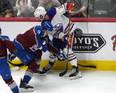 Colorado Avalanche left wing Zach Parise, left, and Edmonton Oilers center Derek Ryan work for the puck during the first period of an NHL hockey game Thursday, April 18, 2024, in Denver. (AP Photo/David Zalubowski)