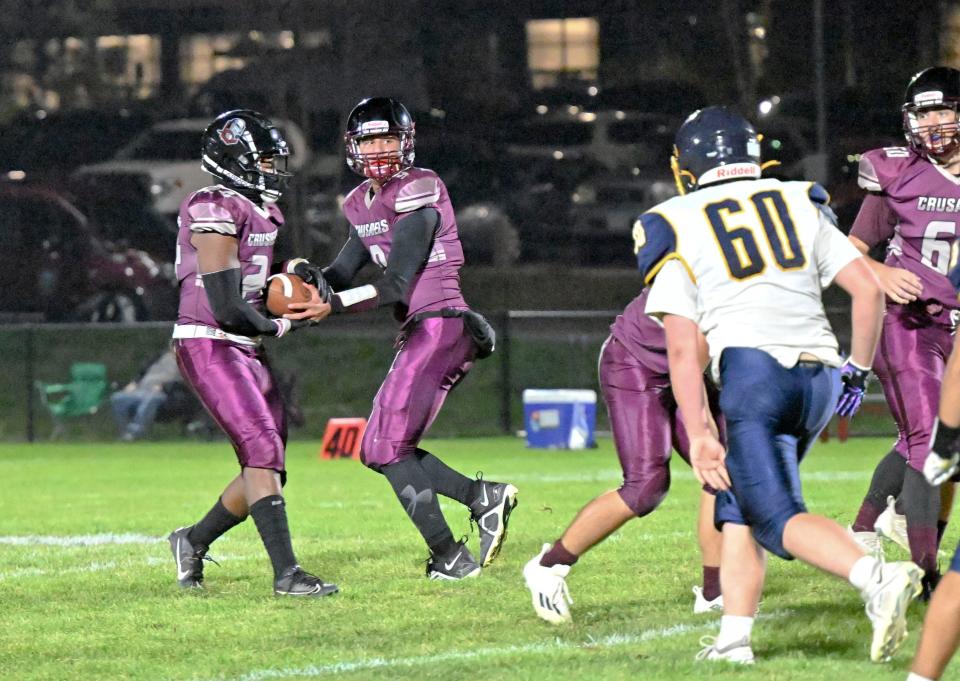 Cape Tech quarterback Aidan Choukri hands off to Rovens Jean-Baptiste against Atlantis Charter school on the new Cape Tech football field.