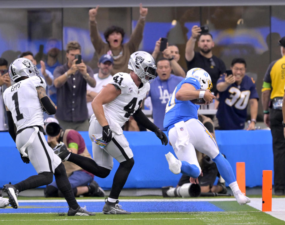 Oct 1, 2023; Inglewood, California, USA; Los Angeles Chargers quarterback Justin Herbert (10) gets past Las Vegas Raiders linebacker <a class="link " href="https://sports.yahoo.com/nfl/players/31708" data-i13n="sec:content-canvas;subsec:anchor_text;elm:context_link" data-ylk="slk:Robert Spillane;sec:content-canvas;subsec:anchor_text;elm:context_link;itc:0">Robert Spillane</a> (41) as he runs for a touchdown in the first half at SoFi Stadium. Mandatory Credit: Jayne Kamin-Oncea-USA TODAY Sports