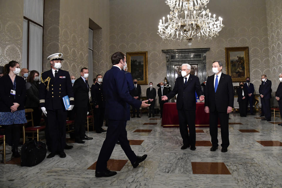 Italy's President Sergio Mattarella, center left, and Italy's Prime Minister Mario Draghi, right, welcome France's President Emmanuel Macron, left, at the Quirinale presidential palace in Rome, Friday, Nov. 26, 2021, prior the Franco-Italian Quirinal Treaty signing. (Alberto Pizzoli / Pool photo via AP)