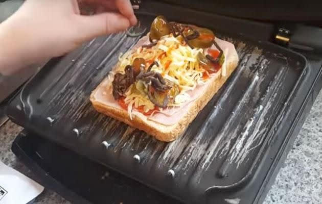 Kirsty can be seen adding big bits of spider as she makes the toastie. Photo: Youtube