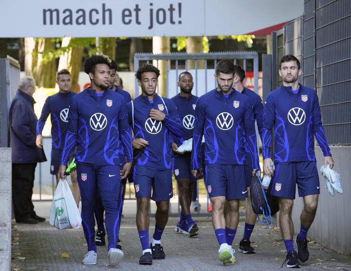 Weston McKennie, Chris Richards, Christian Pulisic and Luca de la Torre, from left, arrive for a training session of the US soccer team in Cologne, Germany, prior to a friendly match against Japan, Thursday, Sept. 22, 2022. A sign reads in German 