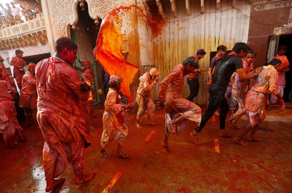 <p>Hindu devotees take part in the religious festival of Holi inside a temple in Nandgaon village, in the state of Uttar Pradesh, India, Feb. 25 2018. (Photo: Adnan Abidi/Reuters) </p>