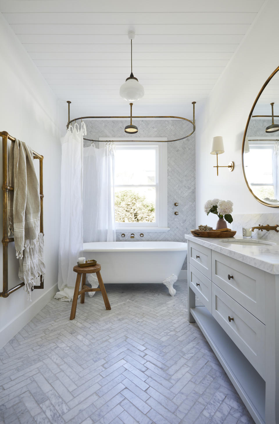 freestanding bath with chevron marble floor tiles in bathroom