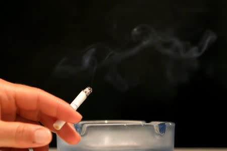 A customer smokes a cigarette in a cafe in Prague, Czech Republic, May 25, 2016. REUTERS/David W Cerny/File Photo