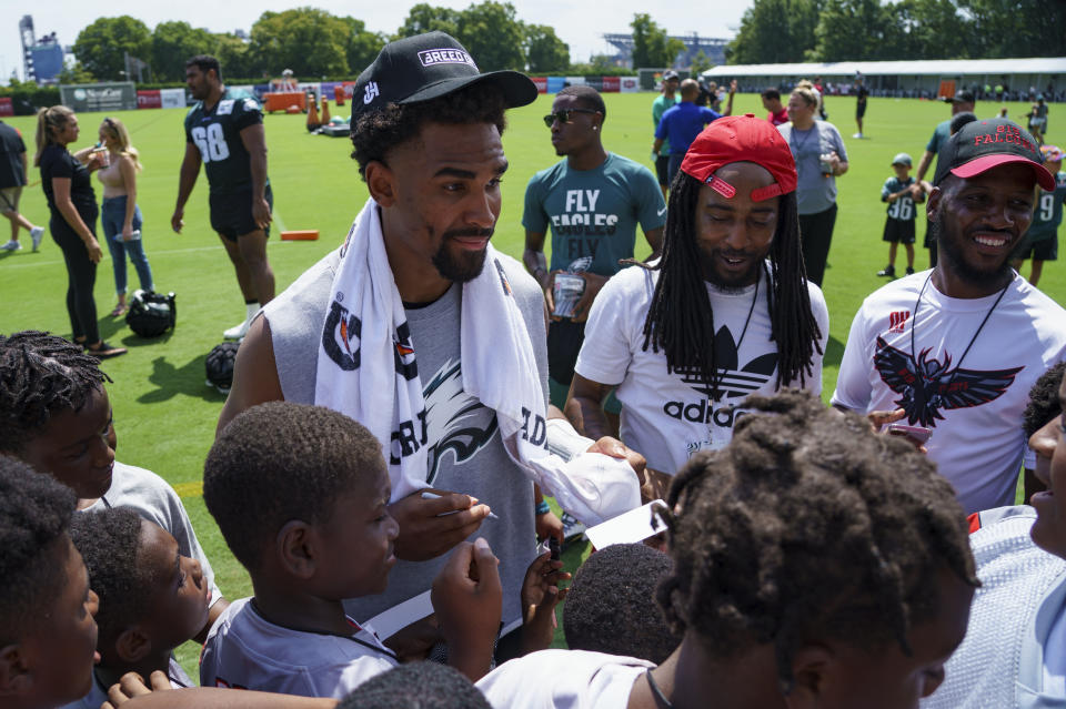 Philadelphia Eagles' Jalen Hurts, center, interacts with the fans during practice at the NFL football team's training camp, Wednesday, July 27, 2022, in Philadelphia. (AP Photo/Chris Szagola)