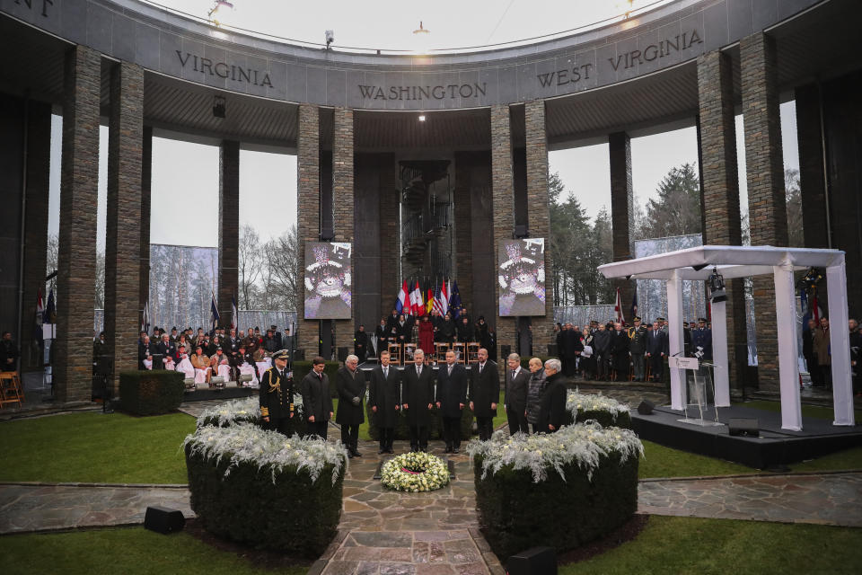 U.S. Secretary of Defence Mark Esper, second left, German President Frank-Walter Steinmeier, third left, Luxembourg's Grand Duke Henri, fourth left, Belgium's King Philippe, fifth left, Poland's President Andrej Duda, sixth left, European Council President Charles Michel, fourth right, and other authorities stand up during a minute of silence during a ceremony to commemorate the 75th anniversary of the Battle of the Bulge at the Mardasson Memorial in Bastogne, Belgium on Monday, Dec. 16, 2019. The Battle of the Bulge, also called Battle of the Ardennes, took place between Dec. 1944 and Jan. 1945 and was the last major German offensive on the Western Front during World War II. (AP Photo/Francisco Seco)