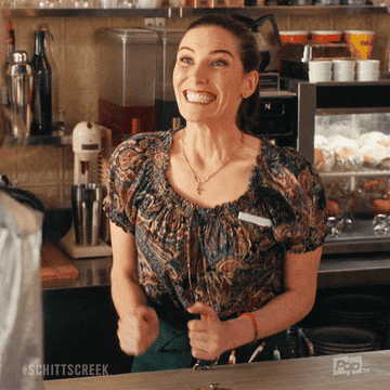 An excited waitress at a restaurant.