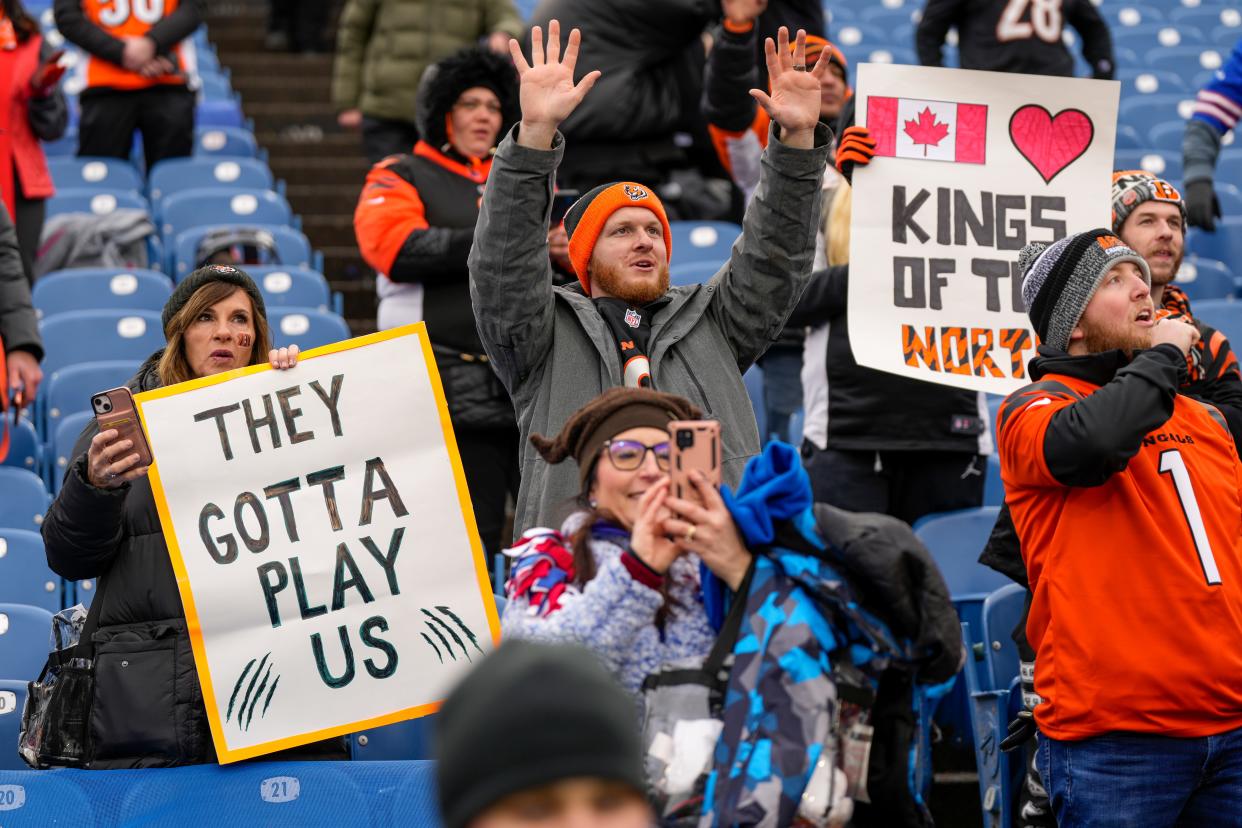 Fans find their seats and call out to players during warmups before the NFL divisional playoff football game between the Cincinnati Bengals and the Buffalo Bills on Sunday at Highmark Stadium in Orchard Park, N.Y.