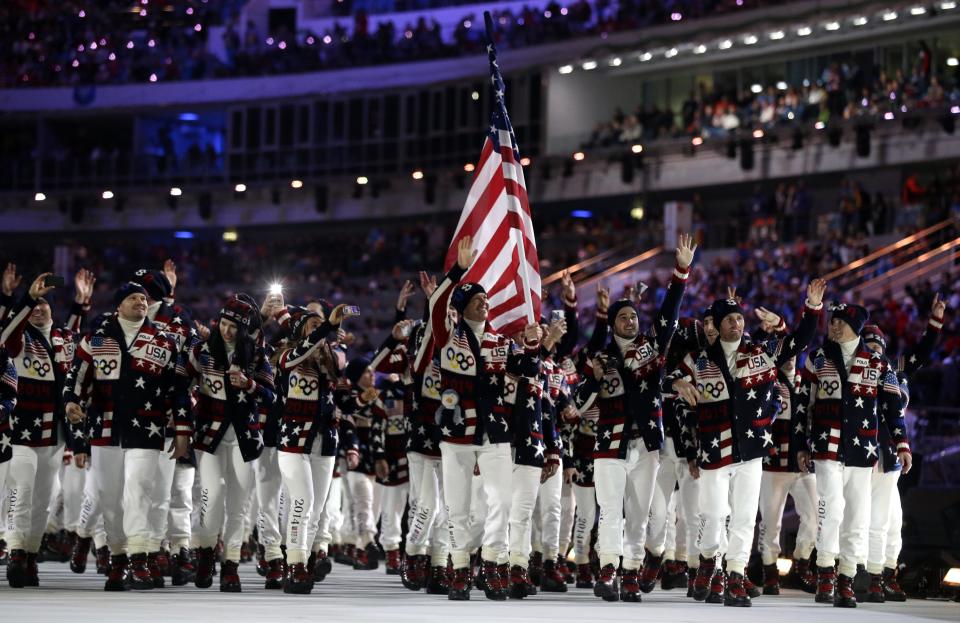 Todd Lodwick of the United States carries the national flag as he leads his team into the stadium during the opening ceremony of the 2014 Winter Olympics in Sochi, Russia, Friday, Feb. 7, 2014. (AP Photo/Patrick Semansky)