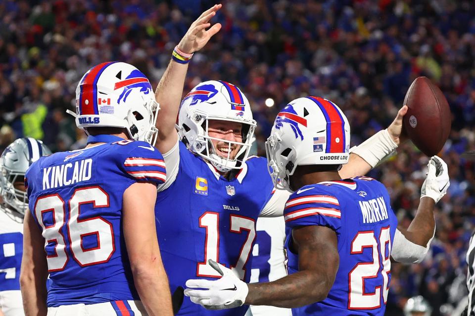 Buffalo Bills quarterback Josh Allen (17) celebrates with teammates after scoring a touchdown against the Dallas Cowboys during the second quarter of an NFL football game, Sunday, Dec. 17, 2023, in Orchard Park, N.Y. (AP Photo/Jeffrey T. Barnes)