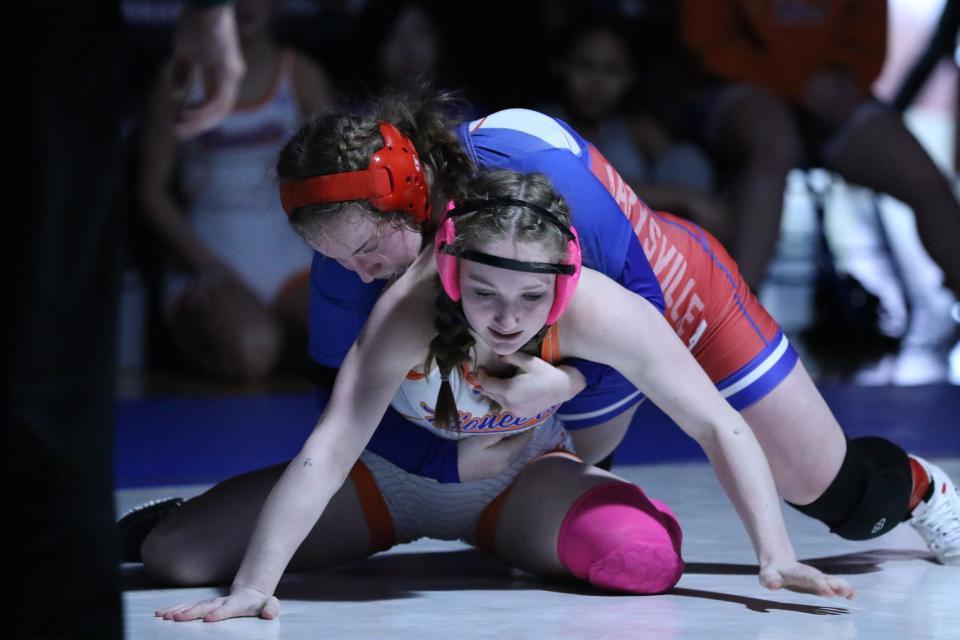 Olentangy Orange's Lucy Scheibeck (bottom) tries to get out from underneath Marysville's Paige Mobley during the OHSWCA girls wrestling state duals Jan. 23.