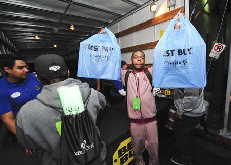 A Xbox fan celebrates after receiving his new Xbox One after midnight during the Xbox One fan celebration and launch party in Los Angeles, California November 22, 2013. REUTERS/Gus Ruelas