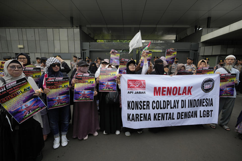 Muslims gather for a rally against British band Coldplay outside the British embassy in Jakarta, Indonesia, Friday, Nov. 10, 2023. Dozens of conservative Muslims marched in Indonesia's capital on Friday calling for cancellation of Coldplay's concert later this month, saying the British band's support of lesbian, gay, bisexual, and transgender will corrupt young people. (AP Photo/Achmad Ibrahim)