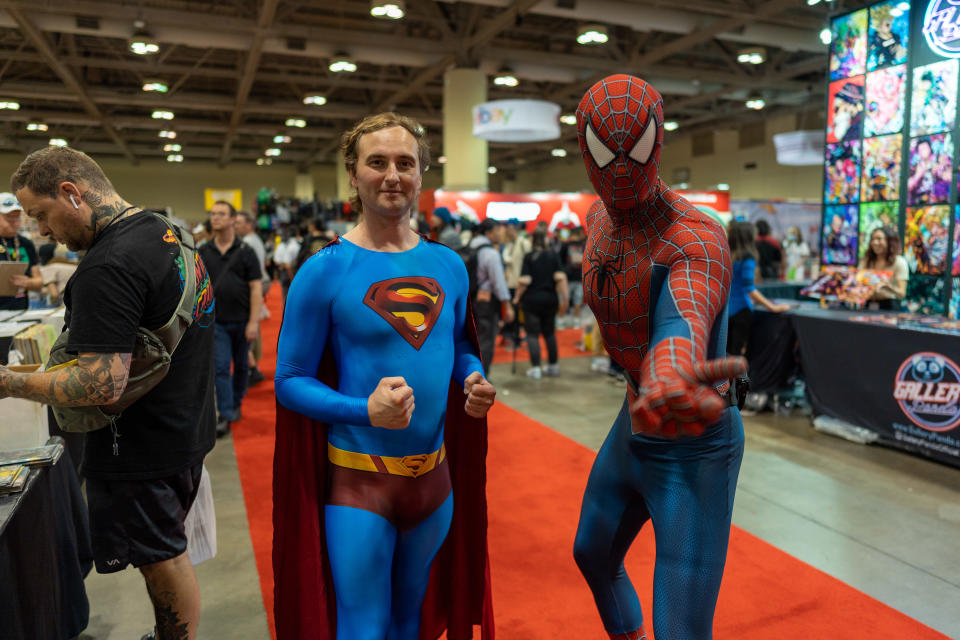 People dressed as Super-Man and Spider-Man pose for a picture at Fan Expo Canada in Toronto on Thursday Aug. 25, 2022. The Fan Expo is back this year, a space for comic enthusiasts, TV and film superfans and cosplayers to unite. THE CANADIAN PRESS/Yader Guzman
