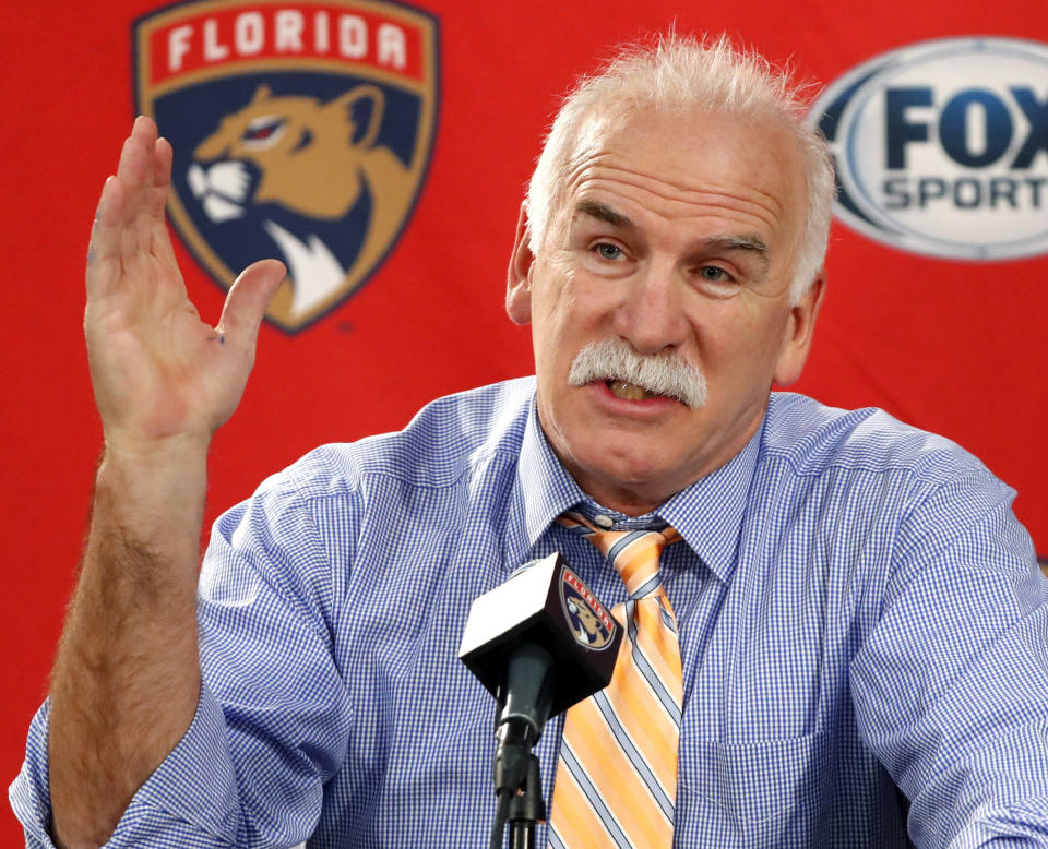 FILE - Florida Panthers head coach and former Chicago Blackhawks coach Joel Quenneville responds to a question during his first visit back to Chicago as a head coach before an NHL hockey game between the Blackhawks and the Panthers, Jan. 21, 2020. The NHL has reinstated executives Stan Bowman and Al MacIsaac and coach Quenneville. They are able to seek employment around the league effective immediately. Bowman, MacIsaac and Quenneville were banned from the league in October 2021 for their roles in the Blackhawks' mishandling of a video coach sexually assaulting a player in 2010. (AP Photo/Charles Rex Arbogast, File)