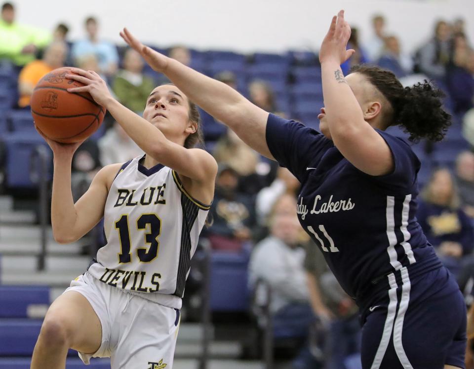 Tallmadge guard Sydney Becks, left, shoots under Hayes' Annalysh Caraballo during the first half of a Division II sectional basketball game, Wednesday, Feb. 21, 2024, in Tallmadge, Ohio.