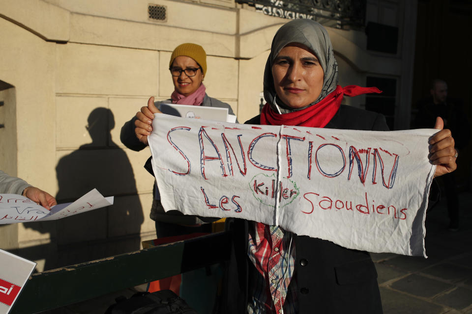 Activist Magda Mahfouz holds a banner reading "Sanction to the Saudi Killers" during a protest closed to the Saudi Arabia embassy, in Paris, Thursday, Oct. 25, 2018. Saudi prosecutors say the killing of journalist Jamal Khashoggi was planned, state-run media reported Thursday, reflecting yet another change in the shifting Saudi Arabian account of what happened to the writer who was killed by Saudi officials in their Istanbul consulate. (AP Photo/Francois Mori)