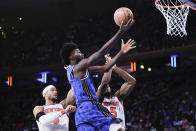 Orlando Magic's Cole Anthony, center, drives past New York Knicks' Precious Achiuwa, right, and Josh Hart during the first half of an NBA basketball game Monday, Jan. 15, 2024, in New York. (AP Photo/Frank Franklin II)