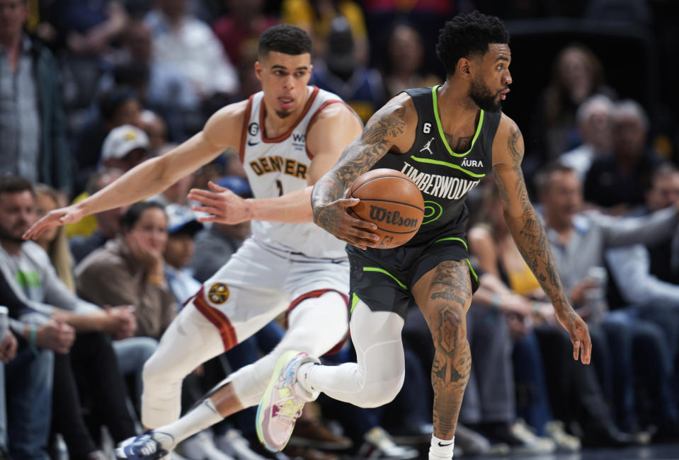 Minnesota Timberwolves guard Nickeil Alexander-Walker drives past Denver Nuggets forward Michael Porter Jr. during the second half of Game 5 of an NBA basketball first-round playoff series Tuesday, April 25, 2023, in Denver. (AP Photo/David Zalubowski)