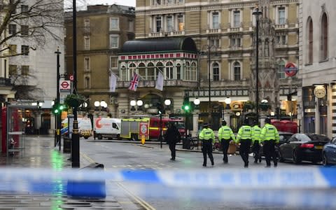 Police officers walk towards Charing Cross station after it was shut due to a gas leak - Credit: David Mirzoeff /PA