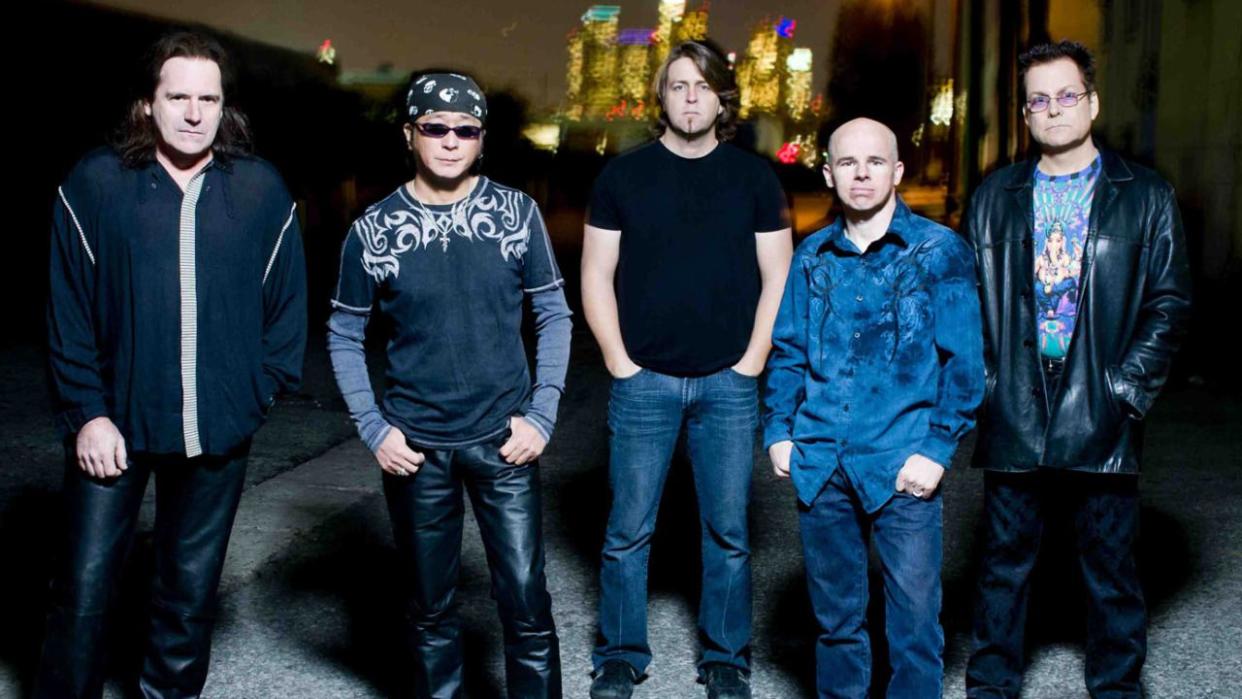  Spock's Beard stand in front of city lights with their hands in their pockets, circa 2013 