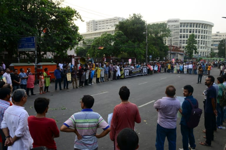 Bangladeshi protesters form a human chain during a demonstration against the killing of a university professor in Dhaka