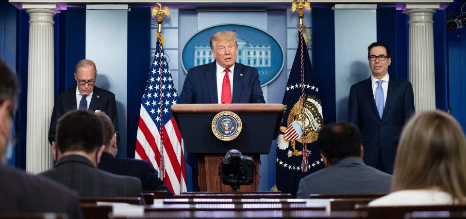 US President Donald Trump, with Director of the National Economic Council Larry Kudlow (L) and US Secretary of the Treasury Steven Mnuchin, speaks to the press in the Brady Briefing Room of the White House in Washington, DC, on July 2, 2020. (Photo by JIM WATSON / AFP) (Photo by JIM WATSON/AFP via Getty Images)