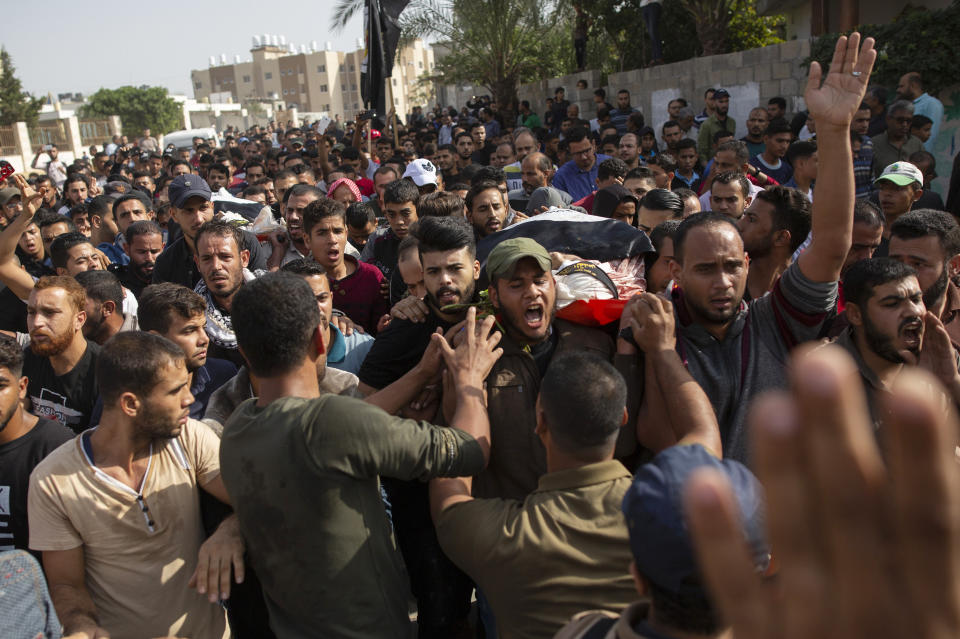 Mourners chant angry slogans as they carry the body of Islamic Jihad militant, Abdullah Al-Belbesi, 26, who was killed in Israeli airstrikes, during his funeral, in the town of Beit Lahiya, Northern Gaza Strip, Wednesday, Nov. 13, 2019. Gaza's Health Ministry said Wednesday that more Palestinians have been killed by ongoing Israeli airstrikes, bringing the death toll in the escalation over the past two days to at least 18. (AP Photo/Khalil Hamra)