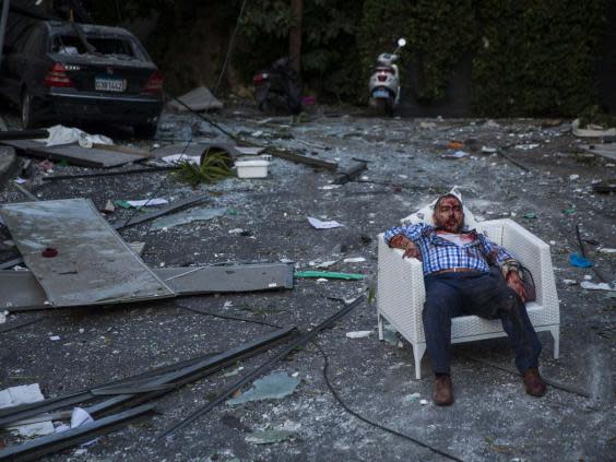 An injured man rests in a chair (Getty Images)