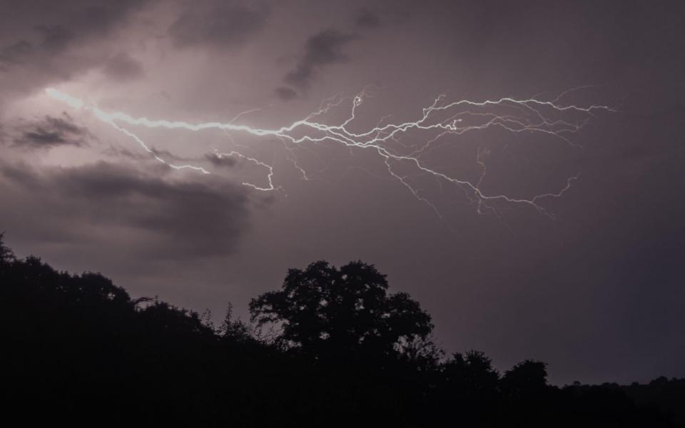 A lightning storm could be seen on the outskirts of Talley village in Carmarthenshire, Wales, on Wednesday night - Ian Jones / Alamy Live News