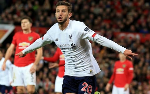 Liverpool's Adam Lallana, center, celebrates after scoring his side's opening goall during the English Premier League soccer match between Manchester United and Liverpool - Credit: AP