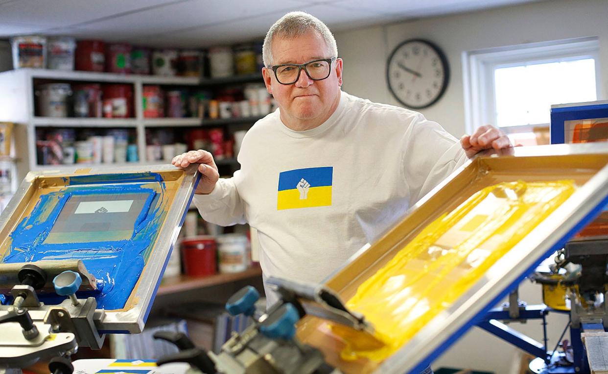 Ron Goodwin, owner of Goodwin Graphics in Cohasset, is producing screened shirts for supporters of Ukraine on Thursday March 3, 2022.