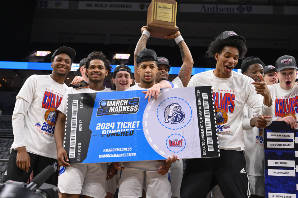 Members of Drake hold a sign signifying that they are going to the March Madness tournament after beating Indiana State after the championship game in the Missouri Valley Conference NCAA basketball tournament, Sunday, March 10, 2024, in St. Louis. (AP Photo/Joe Puetz)