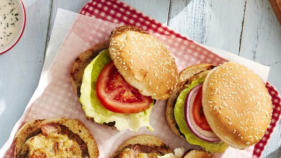 worcestershire glazed burgers arranged on a parchment lined red gingham tray