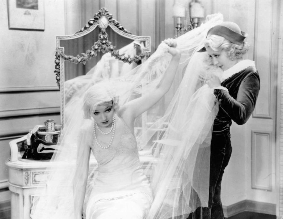 american comic actress joan blondell 1909 1979 struggles with the cumbersome veil of a wedding dress in a scene from an unknown film photo by hulton archivegetty images